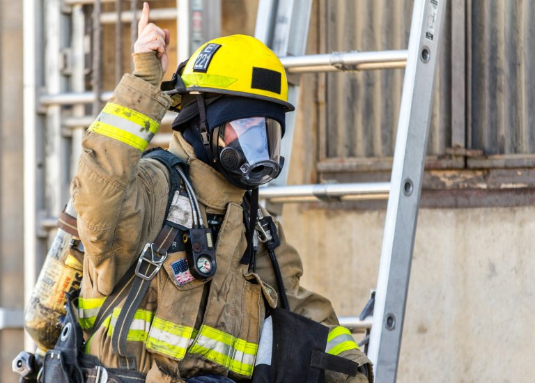 Firefighter on site evaluating fire code and compliance. 