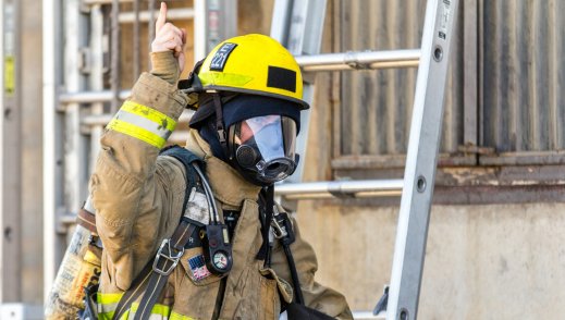 Firefighter on site evaluating fire code and compliance. 